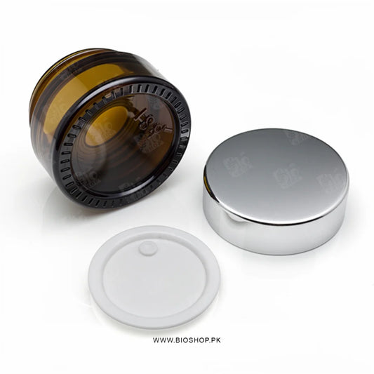Amber Glass Container with silver cap on a white background with