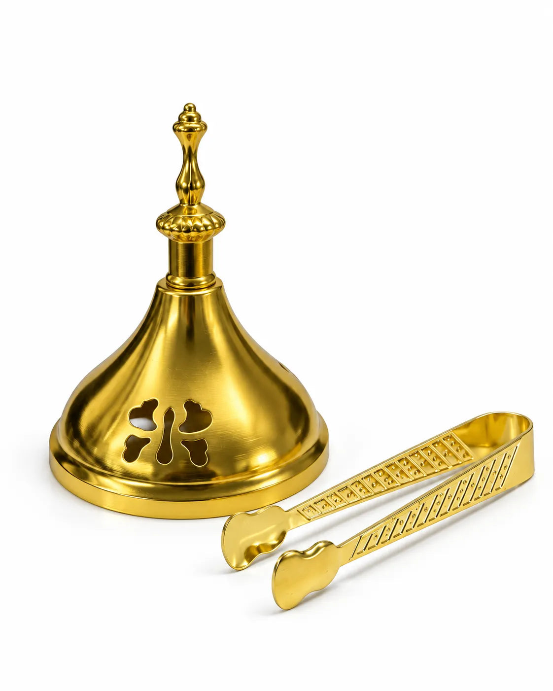 Gold-tone bakhoor burner lid with a tall ornamental handle and cut-out openings beside matching patterned incense tongs.