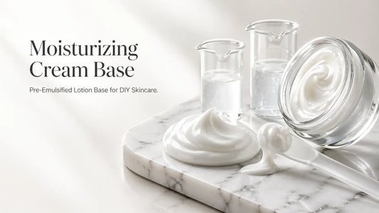 White moisturizing cream base in glass jar with spatula on marble surface for DIY skincare formulation