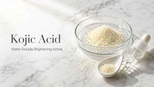 Pale yellow water-soluble kojic acid powder in a glass petri dish on white marble — Bio Shop Ingredient Glossary