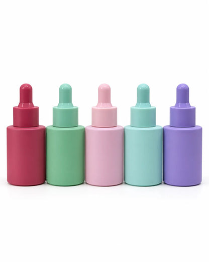 30ml pastel serum dropper bottles in purple green mint and pink on white background