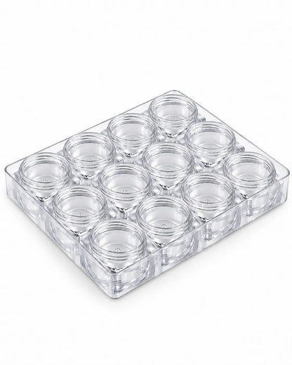 Empty 5gm clear square lip balm jar with an orange screw-on lid against a white background