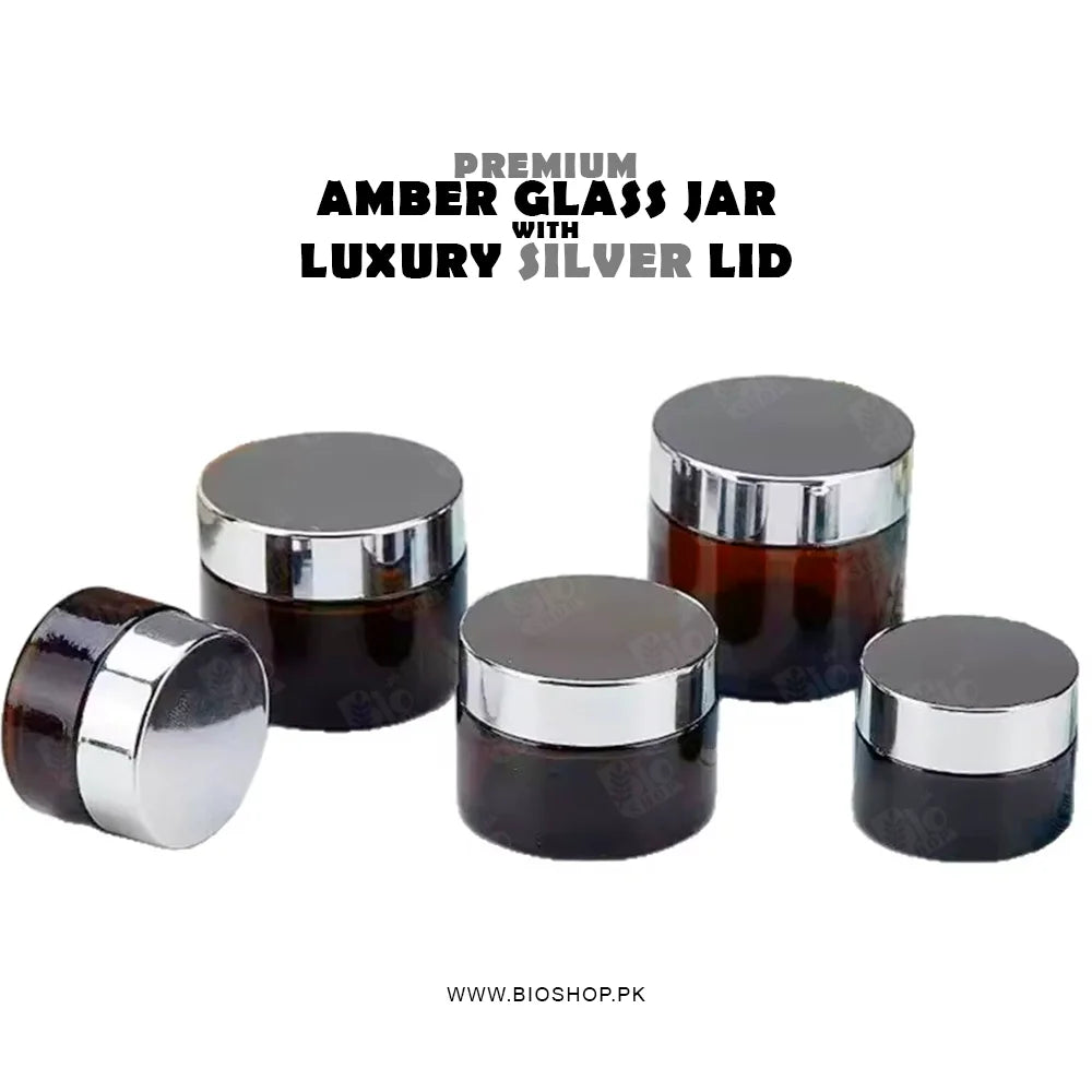 Set of premium amber glass jars with silver lids on a white background