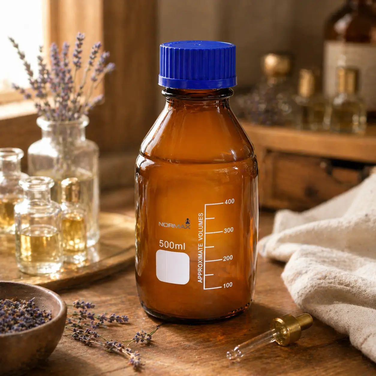 Amber glass bottles on perfumer's workbench with attar oils and blending tools