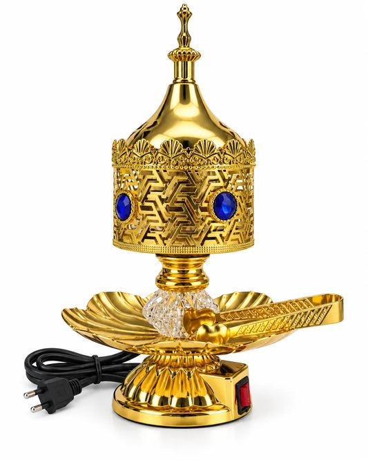 Golden electric bakhoor burner with blue decorative stones, a clear faceted stem, petal-shaped tray, separate lid, and tongs.