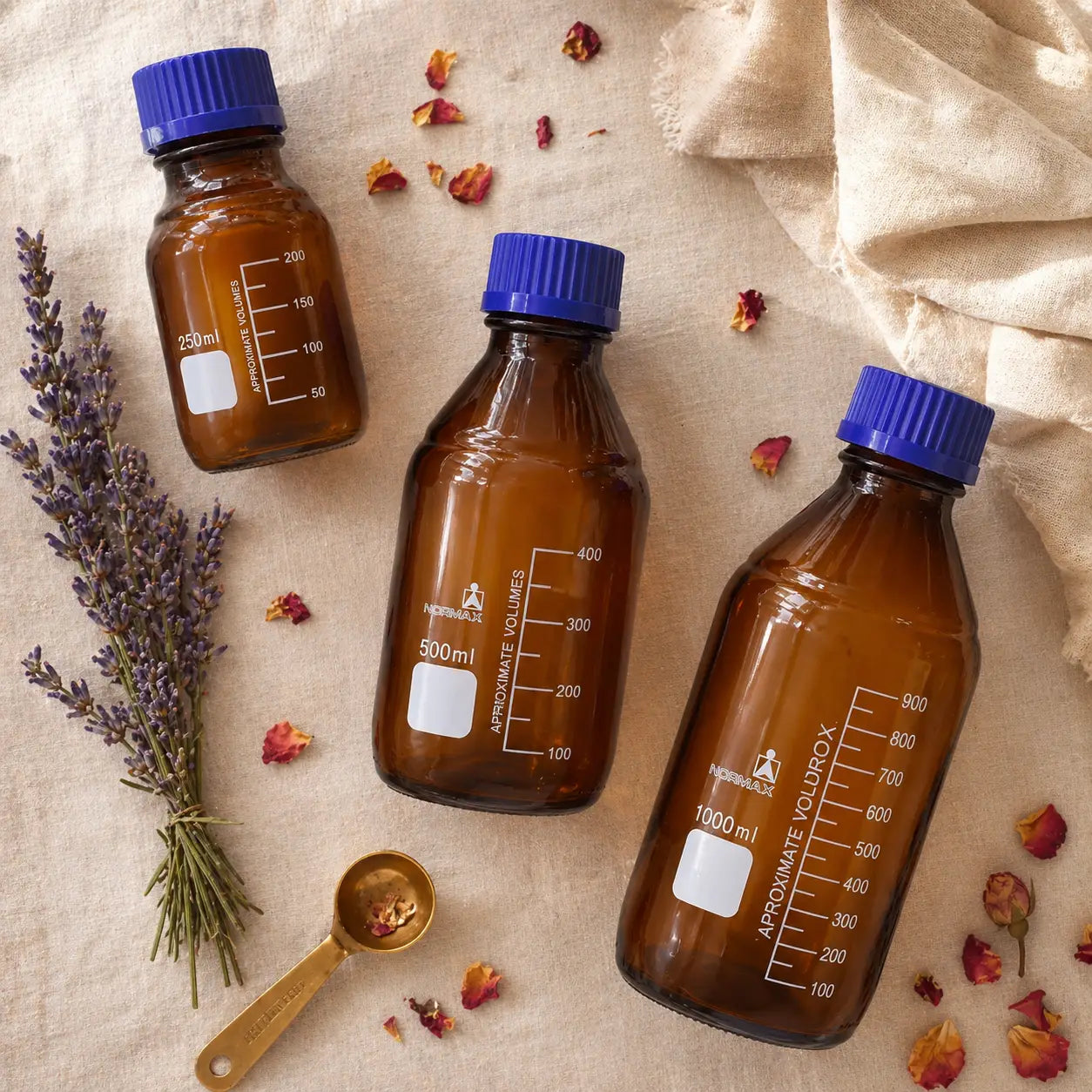Three amber glass bottles side by side — 250ml, 500ml, 1000ml — Bio Shop Pakistan
