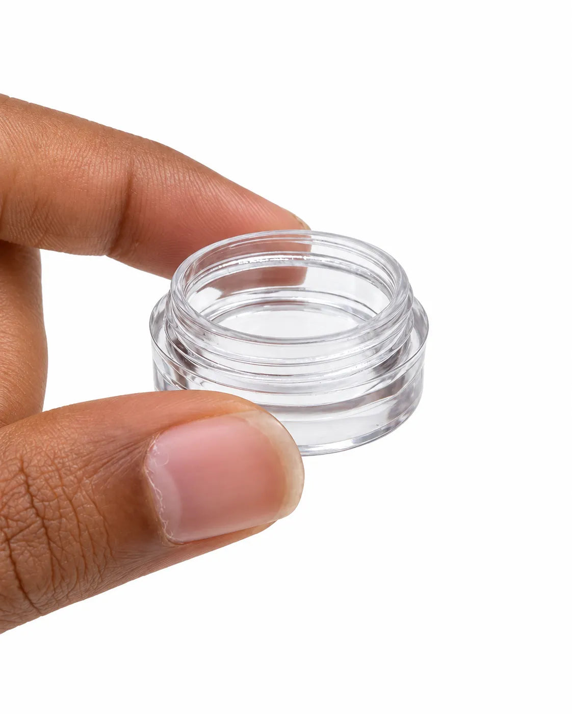 12 empty 5gm round cosmetic jars with black screw lids arranged on white background